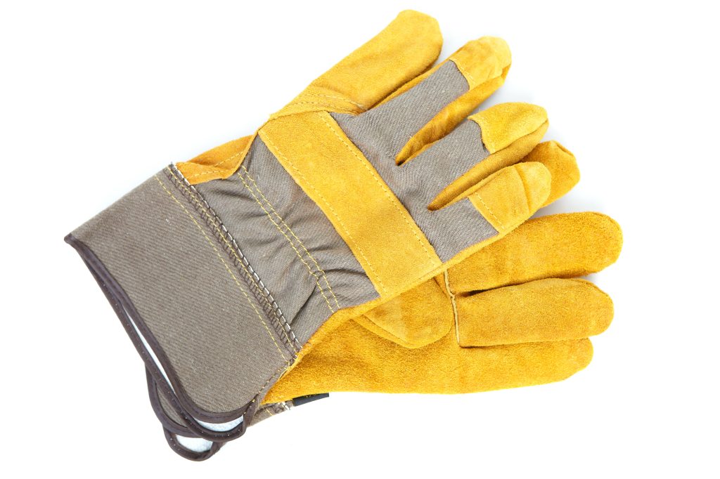 Coarse leather gloves on a white background